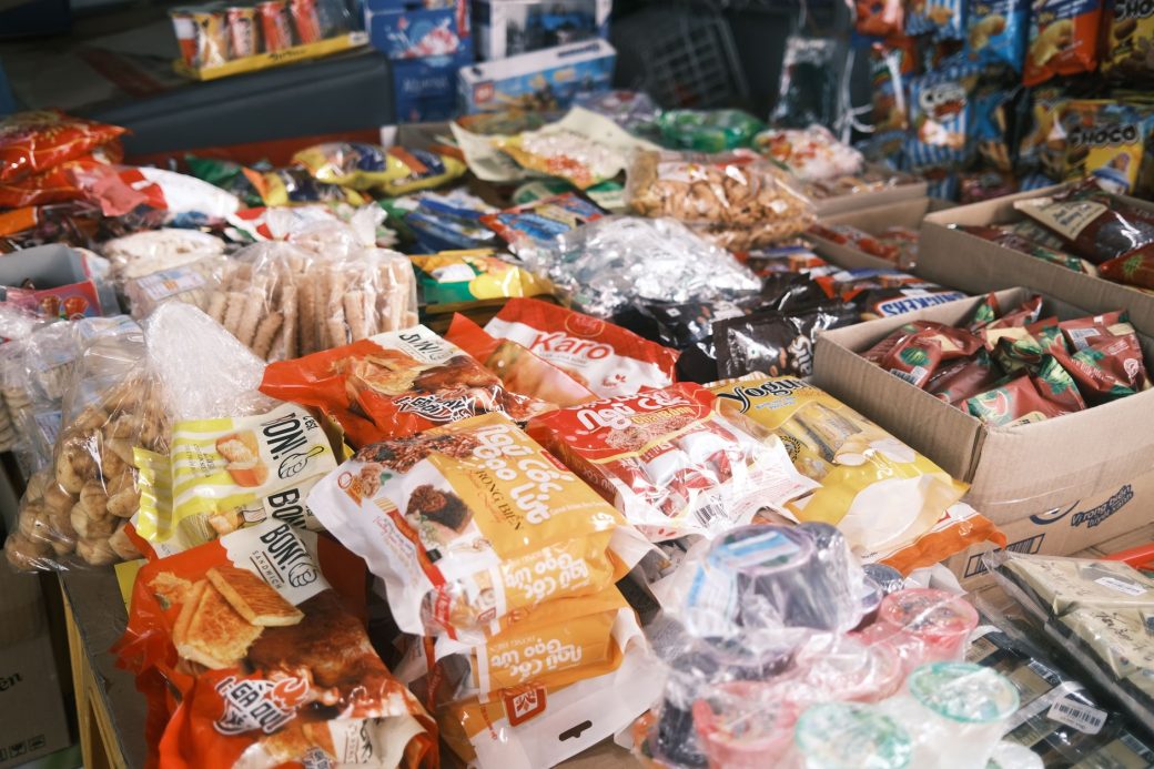 Vibrant array of assorted packaged snacks and candies displayed indoors, perfect for a snack shop or market.